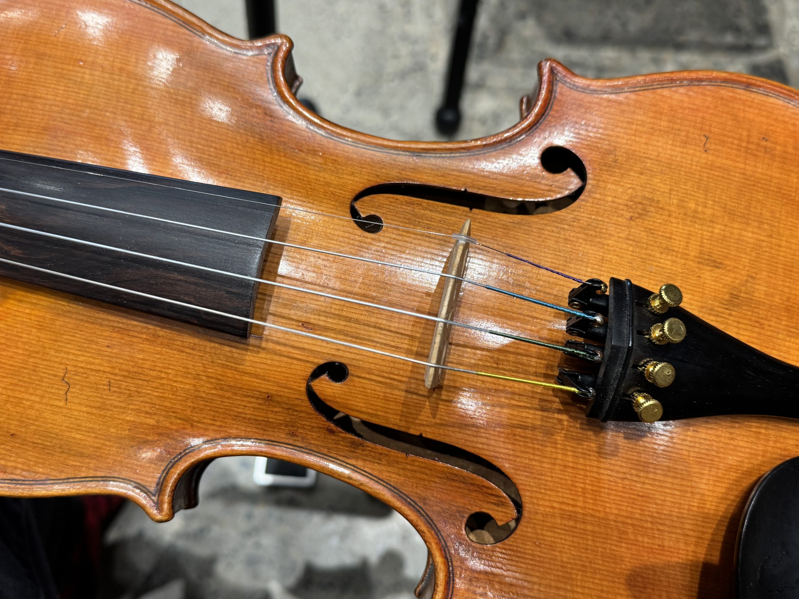 A close up of a violin on a lap.