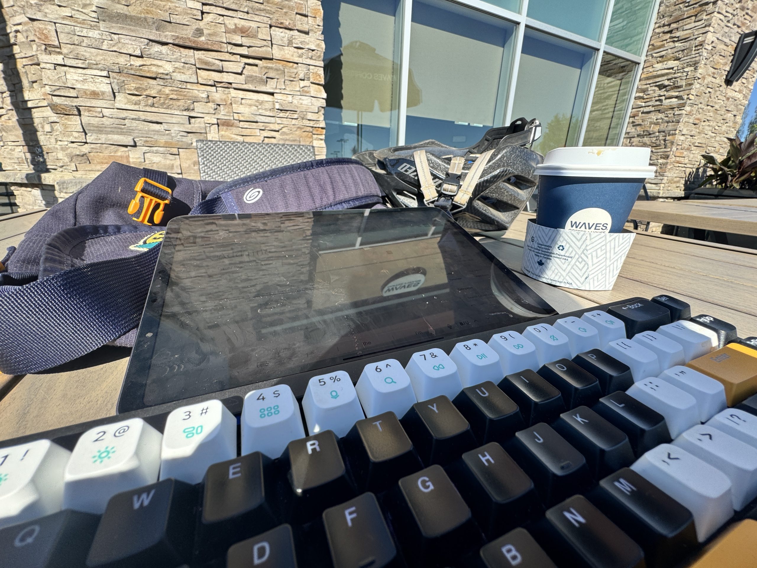 Working at the cafe patio with my bike helmet on the table.